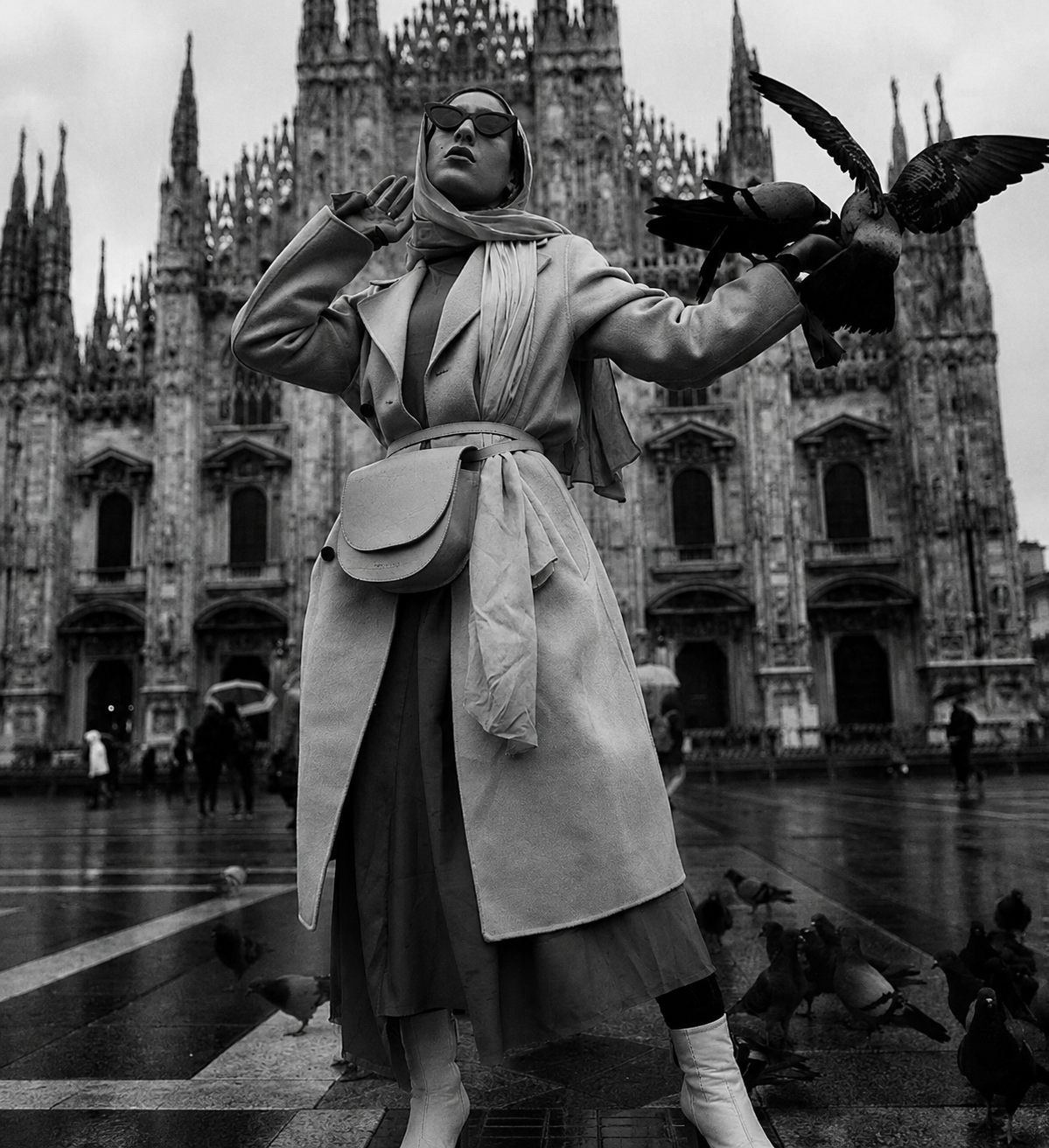 Model wearing vintage cloth trench coat and headscarf in front of historic architecture